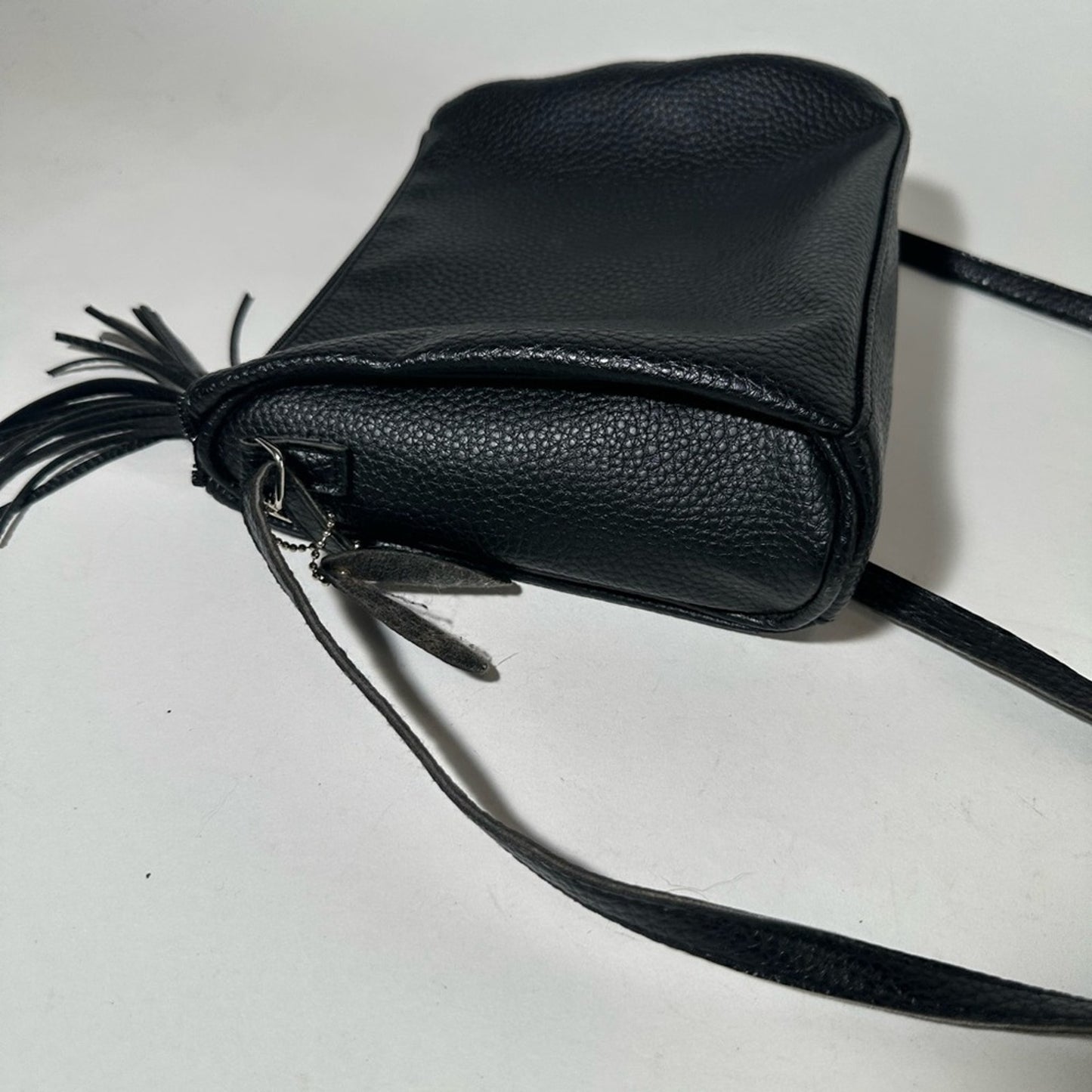 Sleek Black Crossbody Bag with Adjustable Strap and Tassel