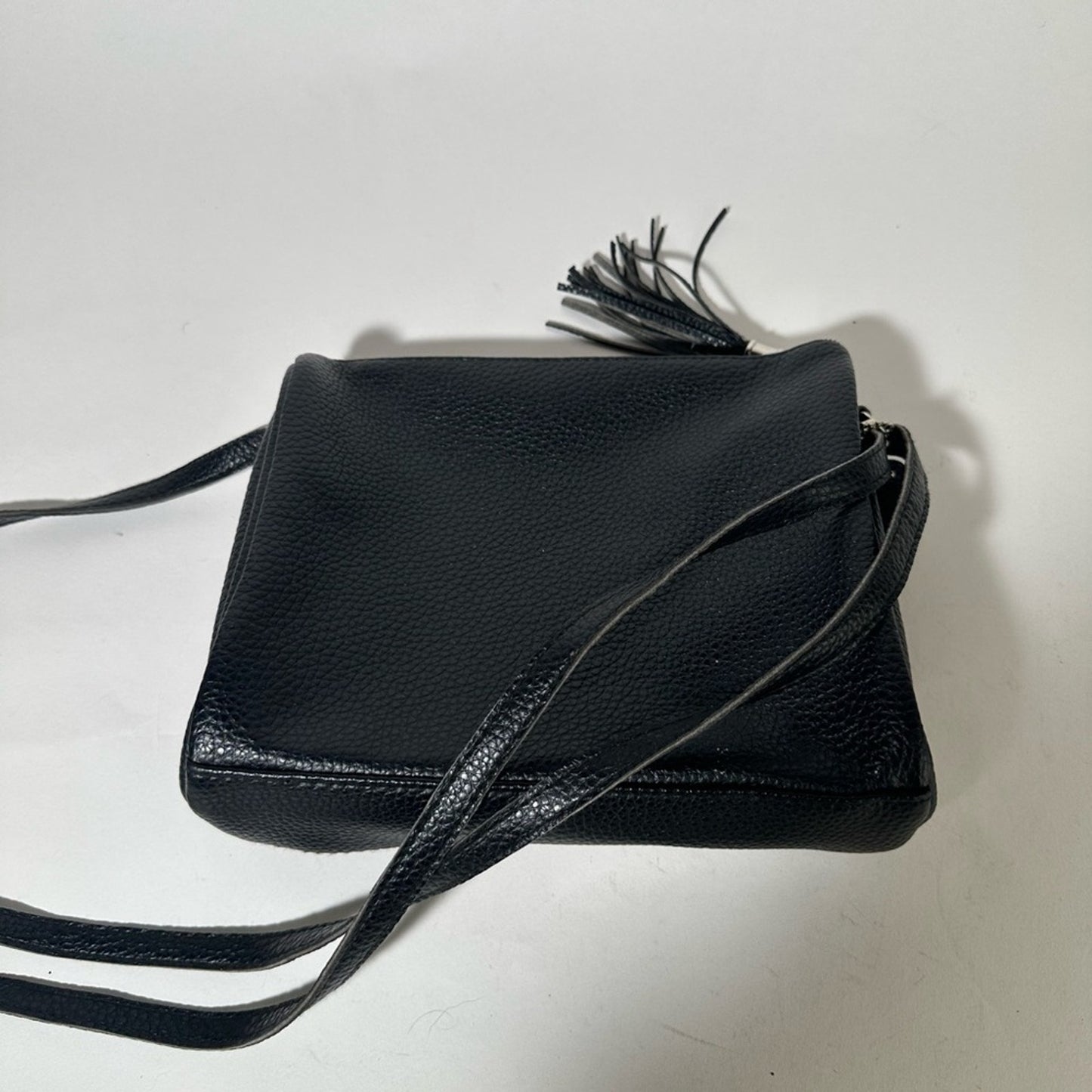 Sleek Black Crossbody Bag with Adjustable Strap and Tassel