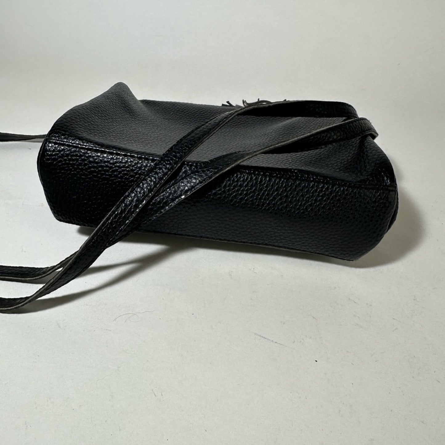 Sleek Black Crossbody Bag with Adjustable Strap and Tassel